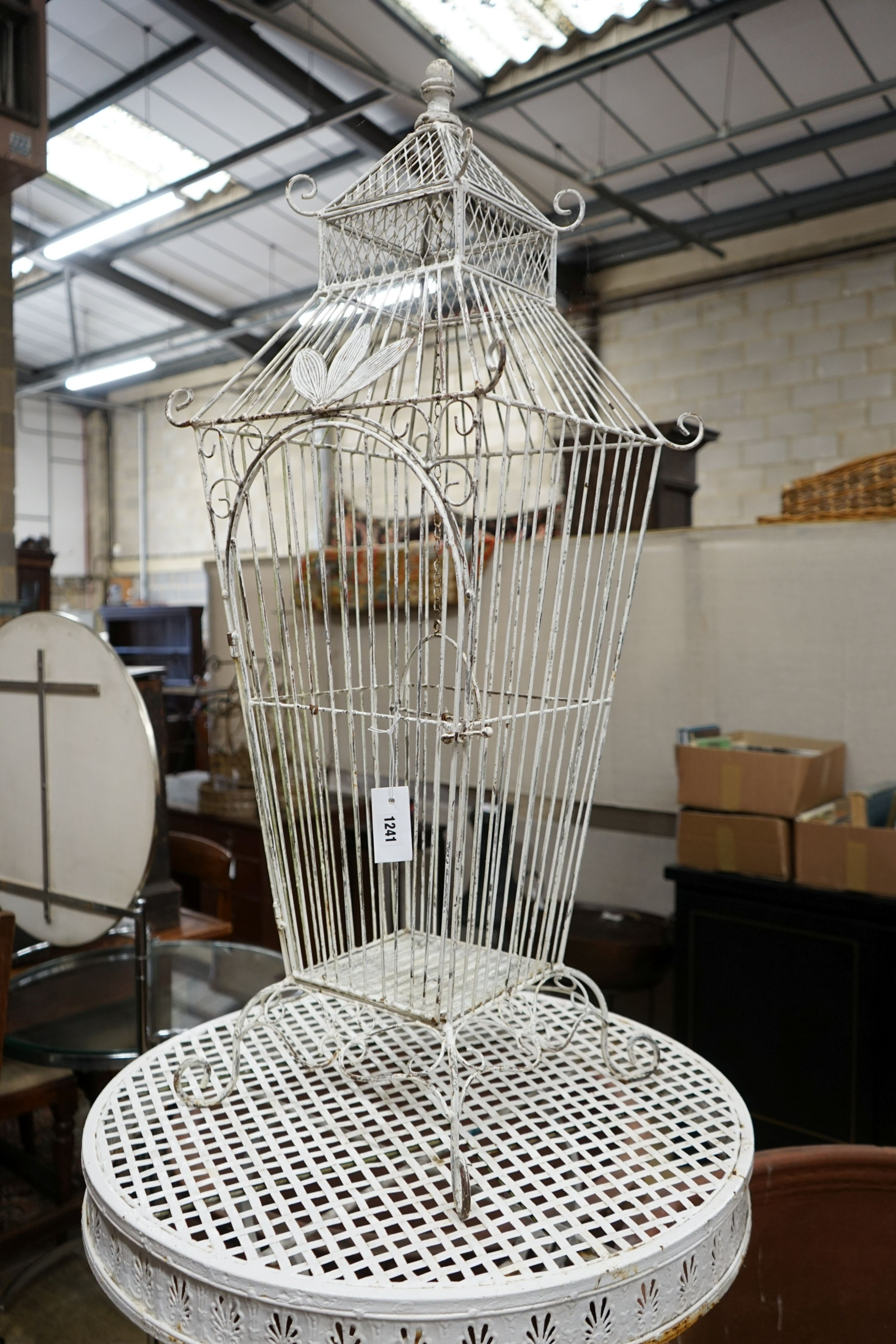 A white painted wirework birdcage, height 110cm together with a painted metal garden bar table